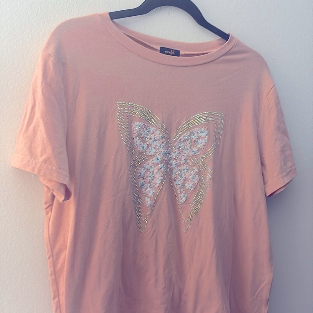 T-shirt features an embroidered butterfly design with sparkling details.
